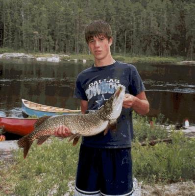 Travis with the biggest catch of his life, a 15# northern, caught at our final campsite. What a monster! Photo by Timo Gosselin