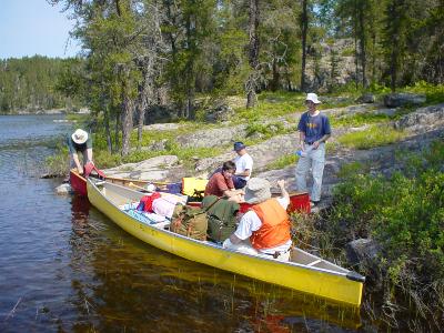 Al Bayne, Timo (in red canoe), Doug (in yellow canoe), Martin (standing), and Don (sitting on shore), loading on morning of Day 2